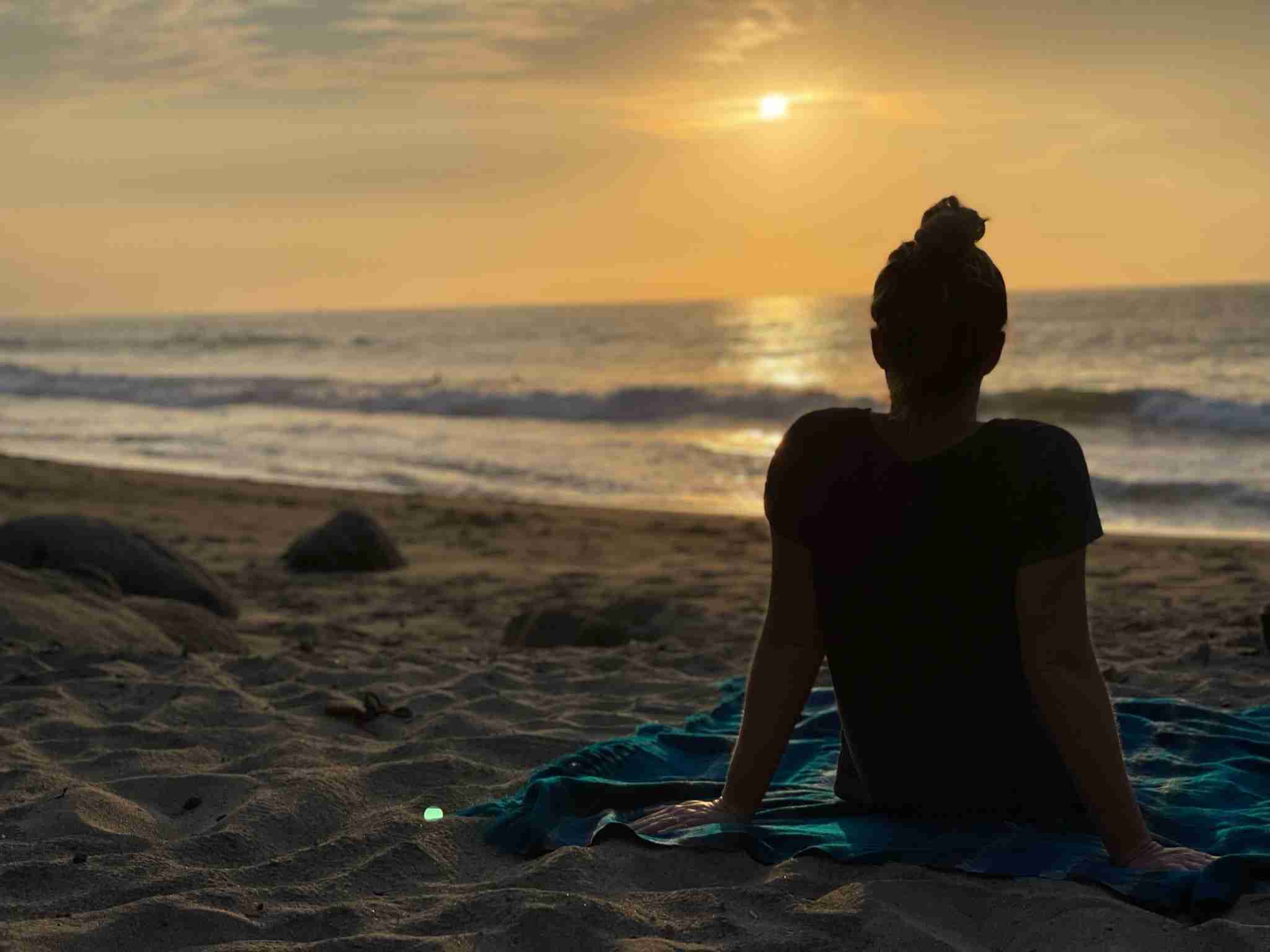 Jen sitting on a beach in Sayulita Mexico